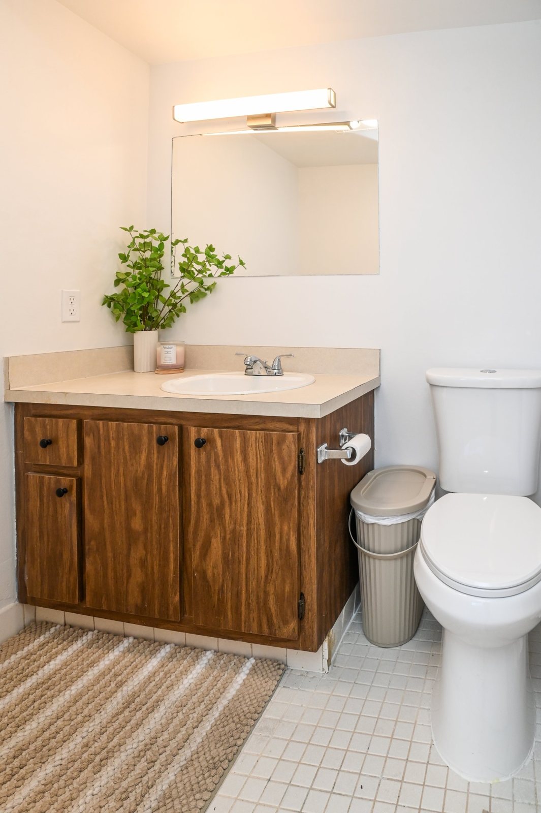 Bathroom with wood vanity and tile floor