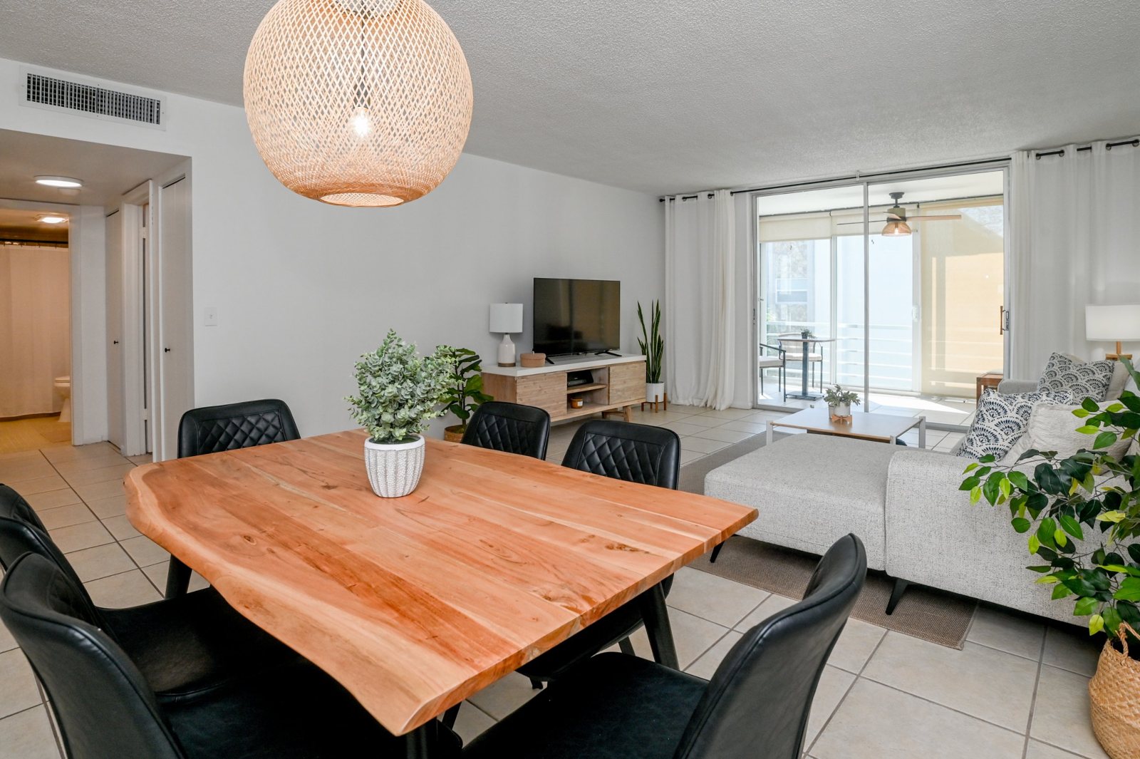 Dining table and living area looking toward the balcony